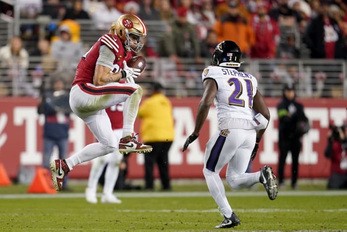 San Francisco 49ers tight end George Kittle catches a pass in front of Baltimore Ravens cornerback Brandon Stephens.